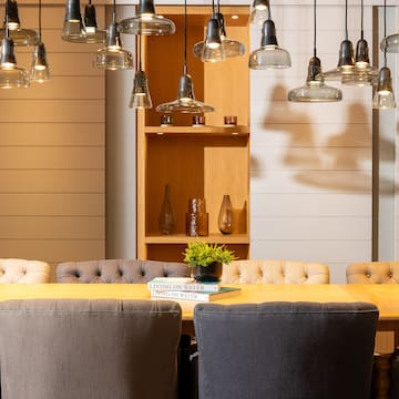 a dining table with chairs and a book on it