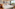 Contemporary hotel bedroom: white bed, card art, wooden details, and bright window view.