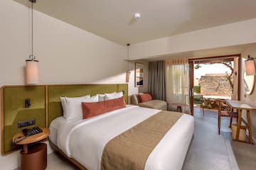 a bedroom with a bed and a couch.