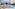 Sunny children's water park with slide, splash pad, lounge chairs.