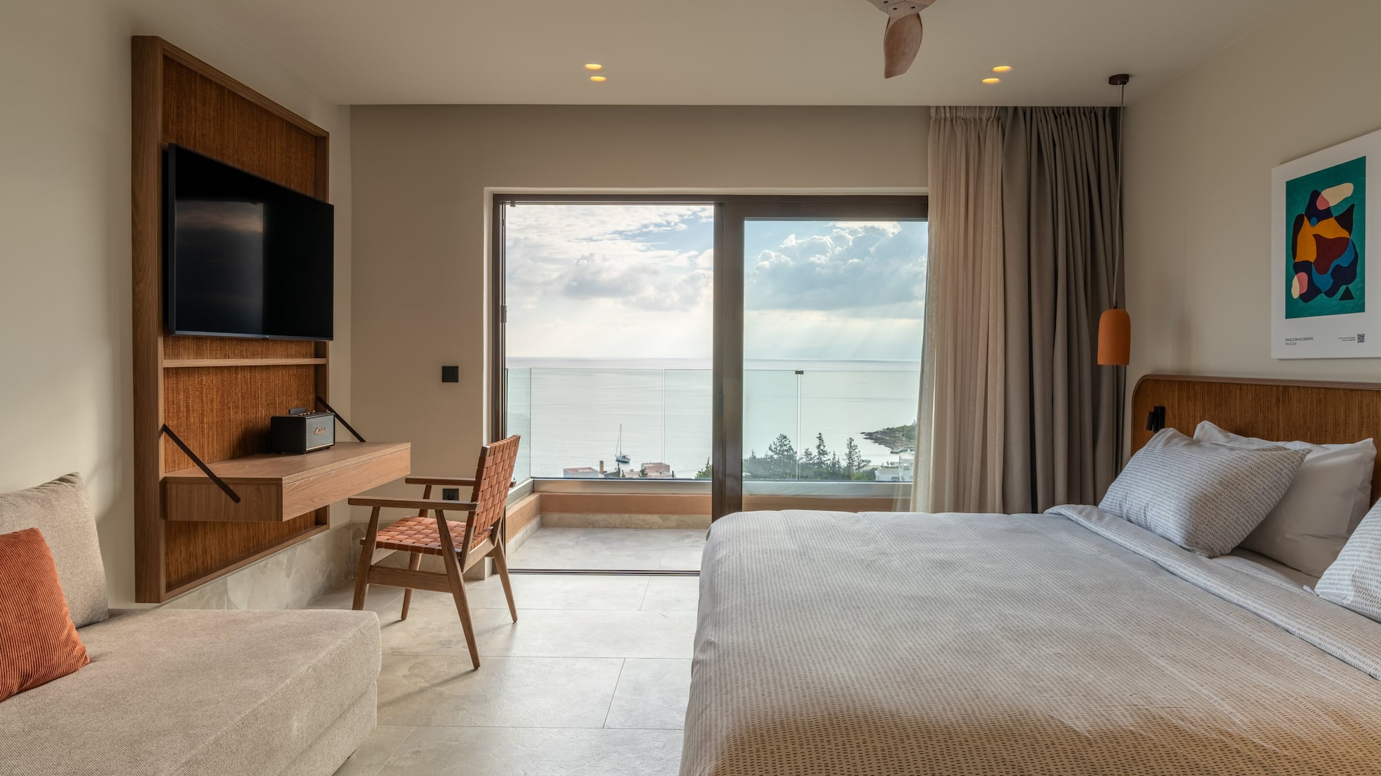 a bedroom with a large window and a bed