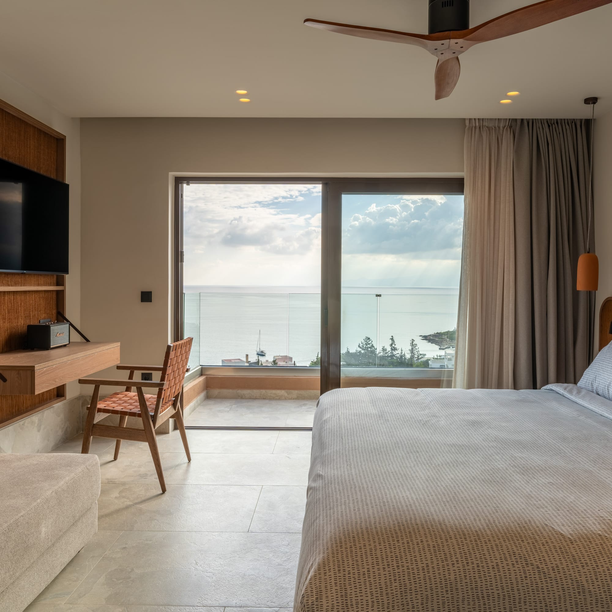 a bedroom with a large window and a bed