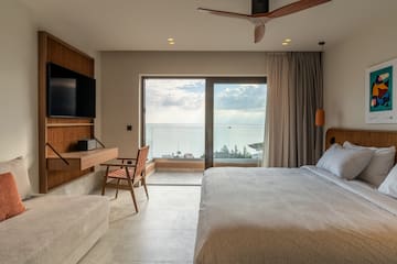 a bedroom with a large window and a bed