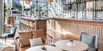 a room with a bar and tables