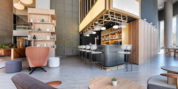 a room with a bar and chairs