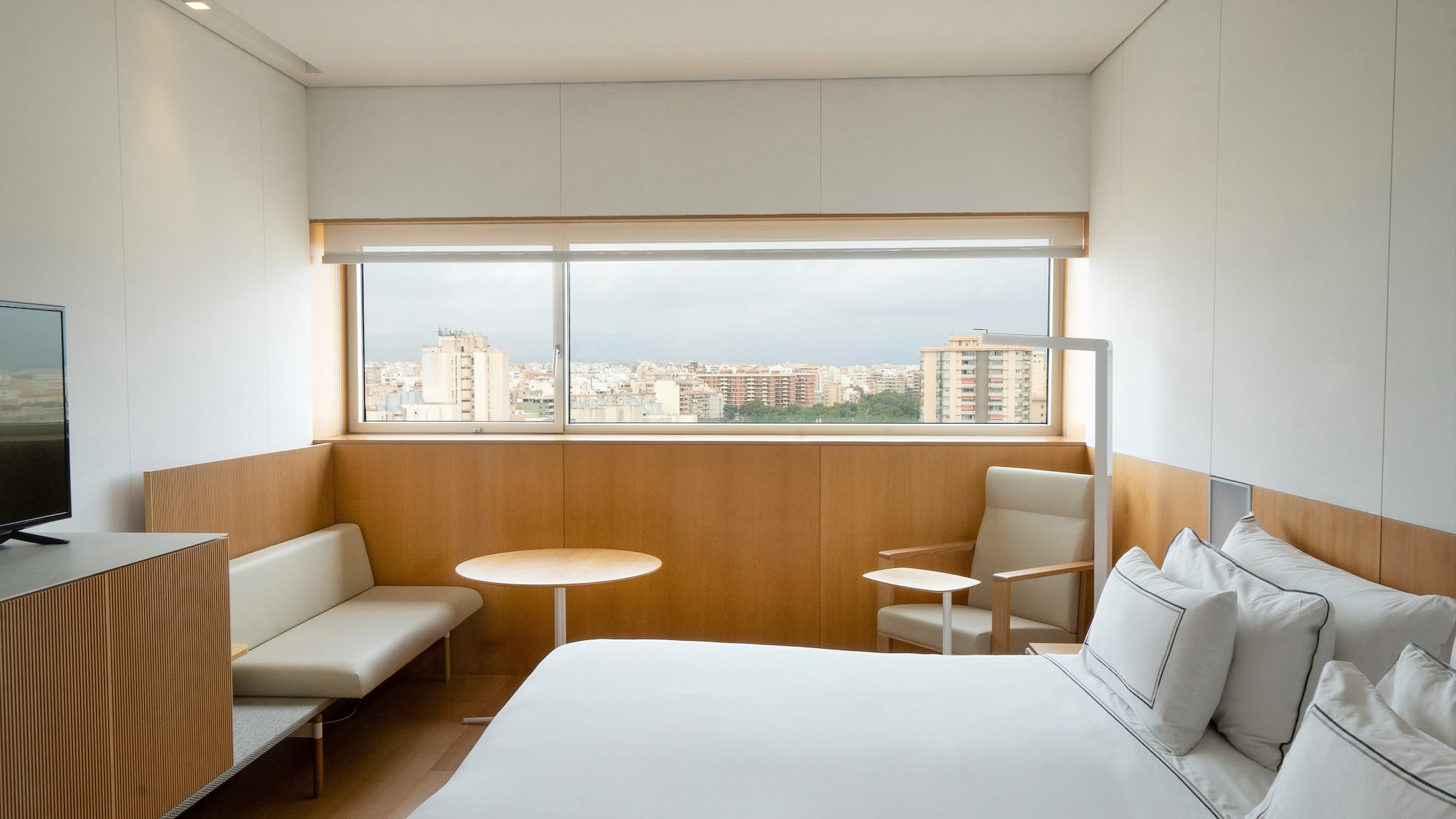 a room with a bed and a table and chairs