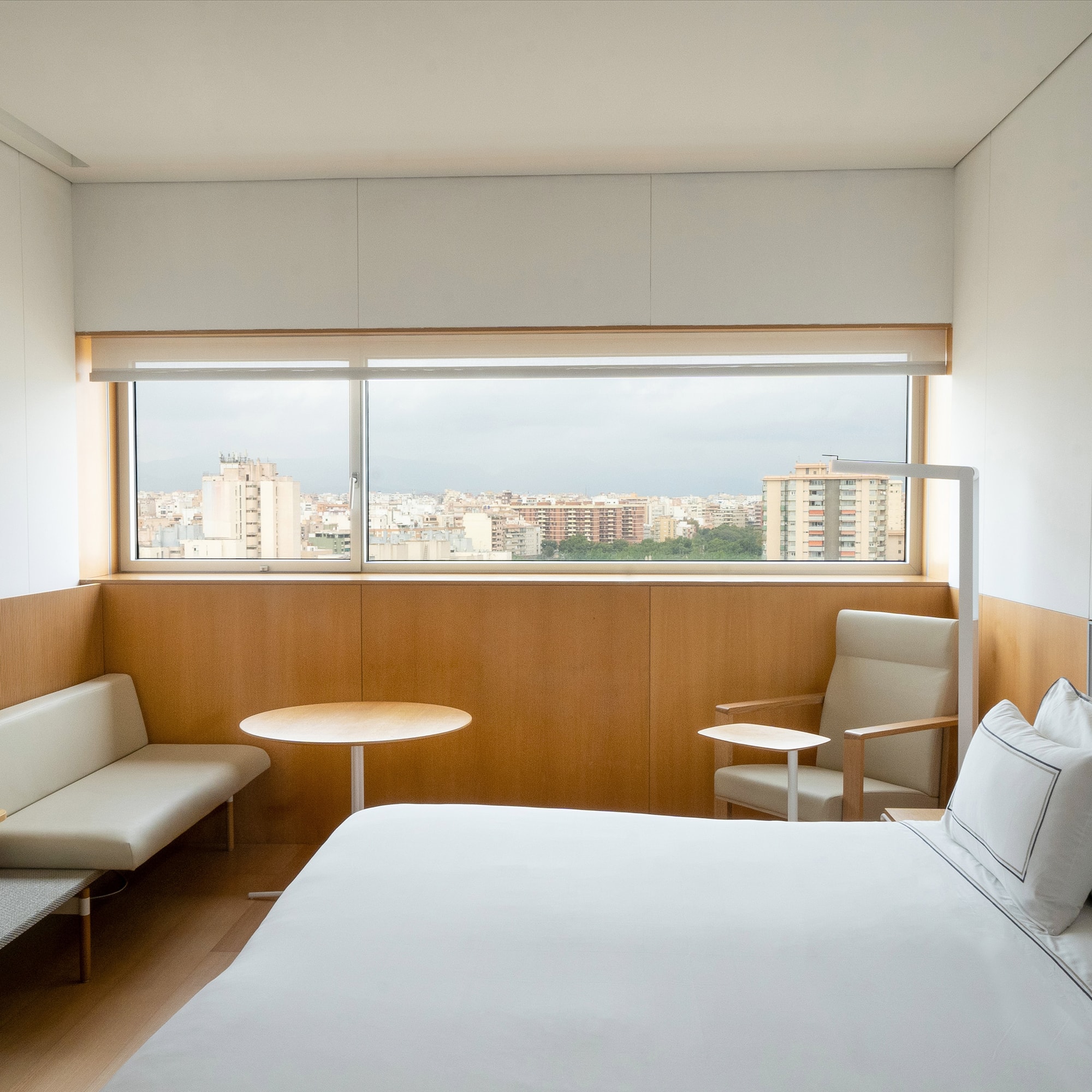 a room with a bed and a table and chairs