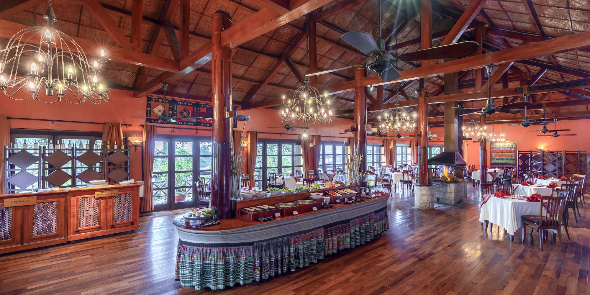 a large room with a large table and a ceiling fan