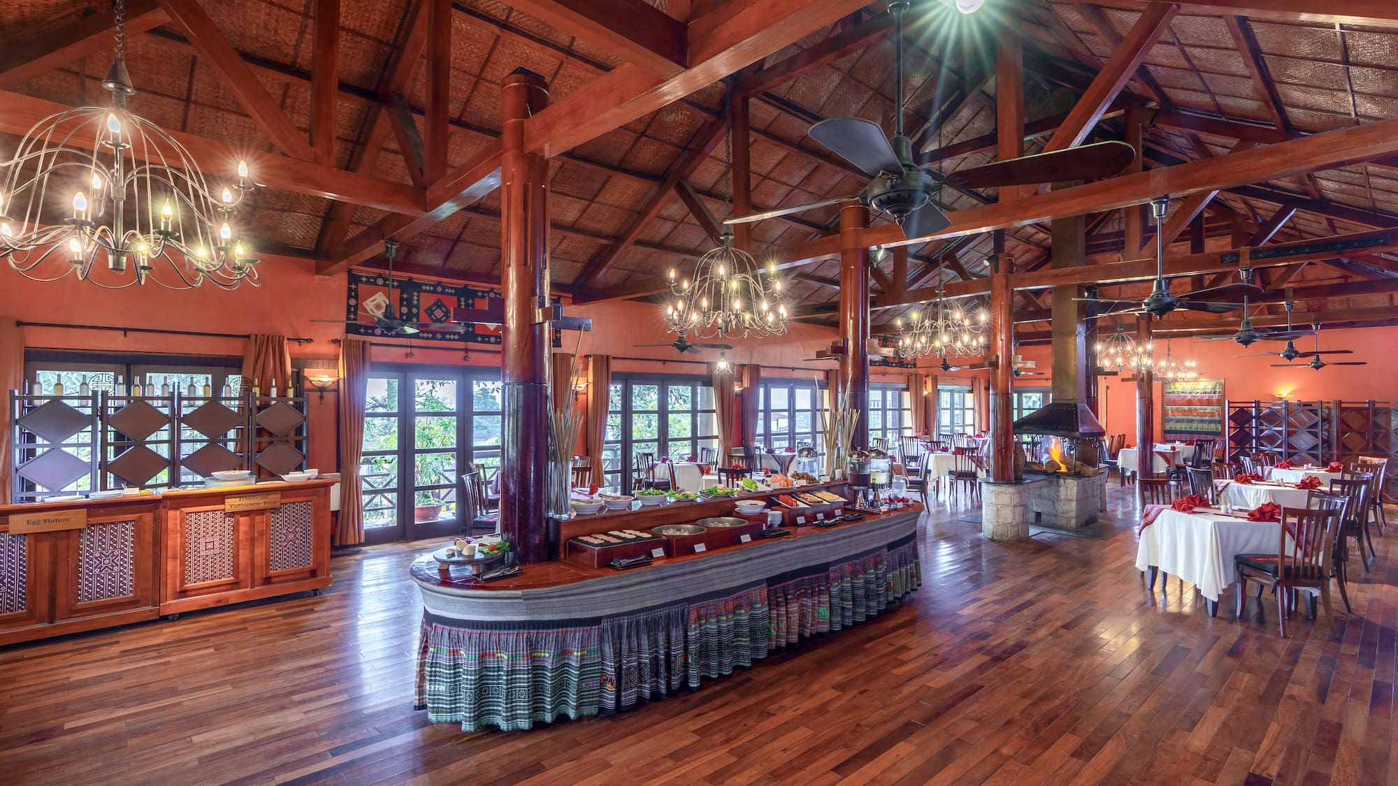 a large room with a large table and a ceiling fan