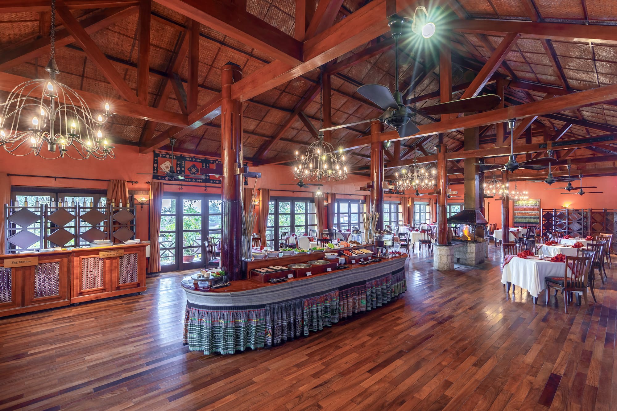 a large room with a large table and a ceiling fan