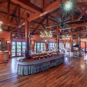 a large room with a large table and a ceiling fan