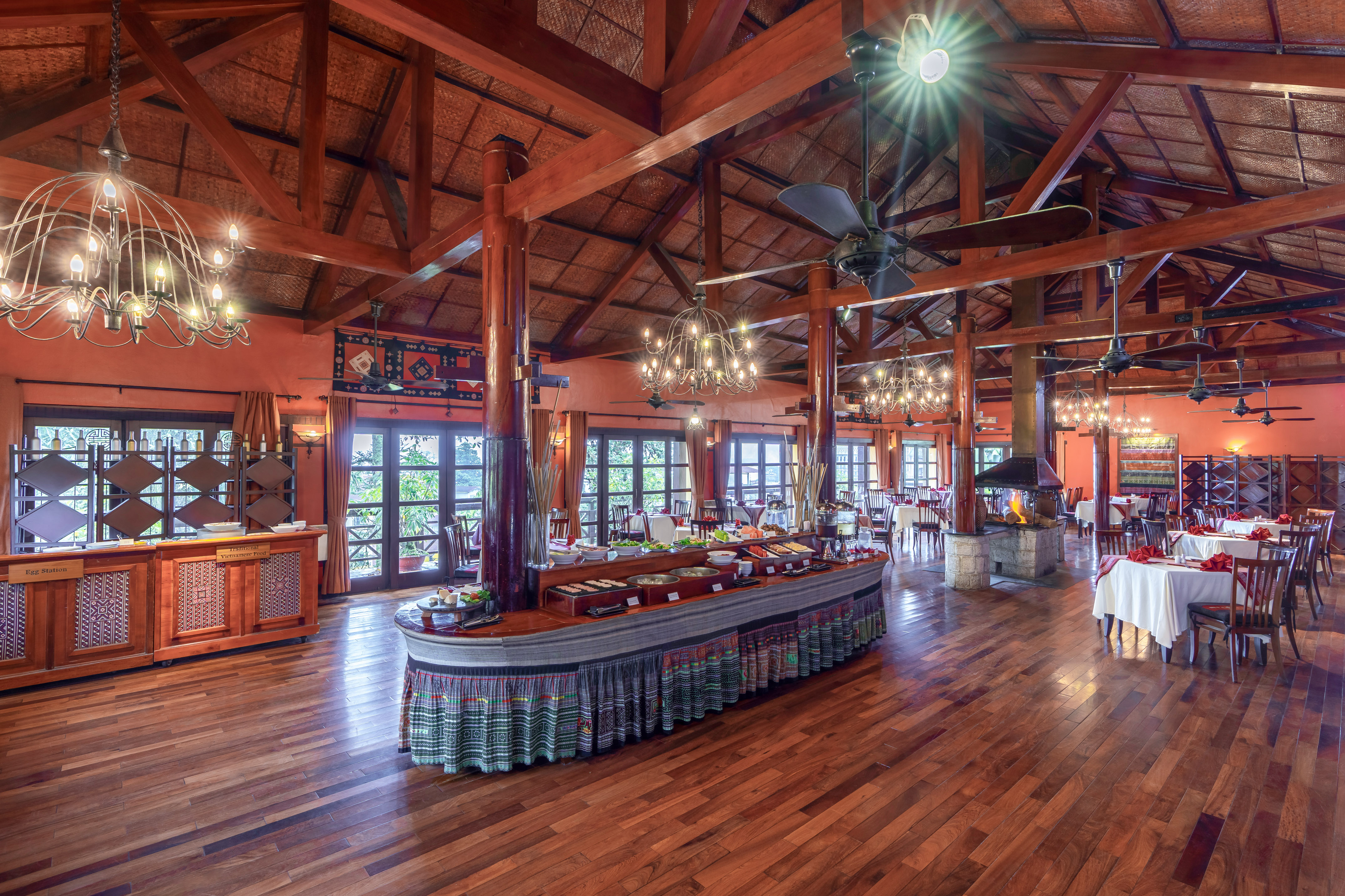 a large room with a large table and a ceiling fan