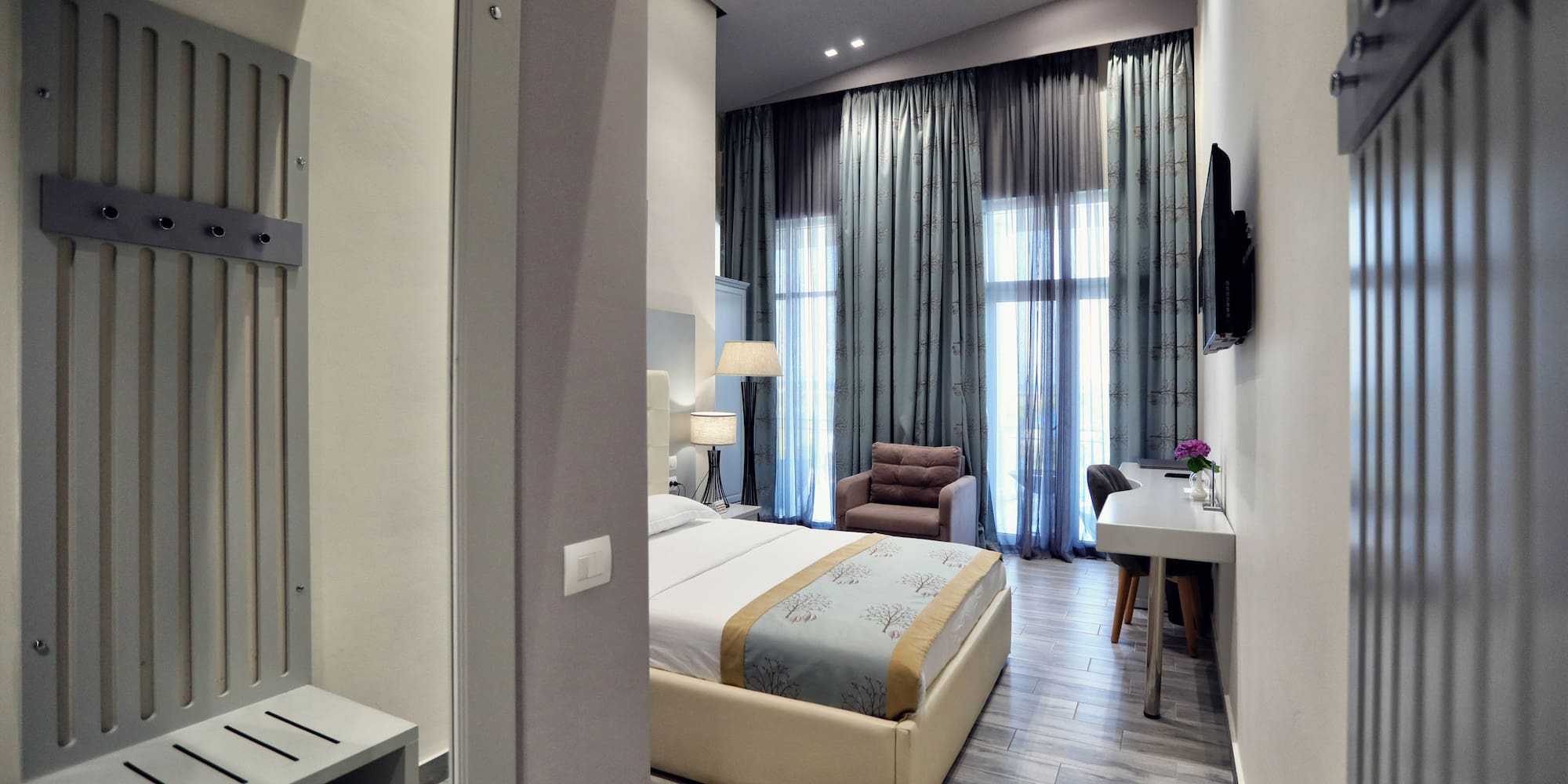 a bedroom with a bed and a desk