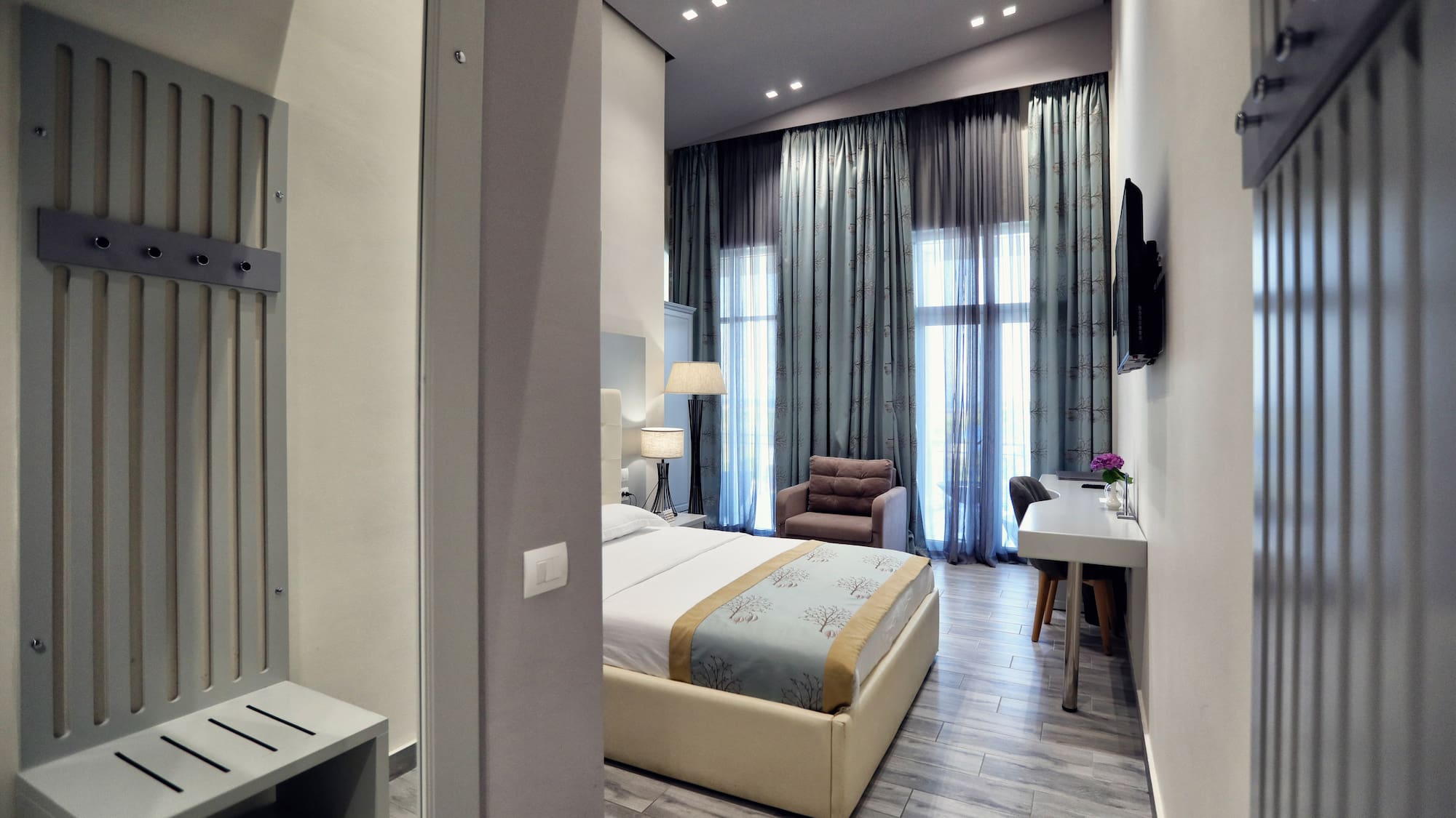 a bedroom with a bed and a desk