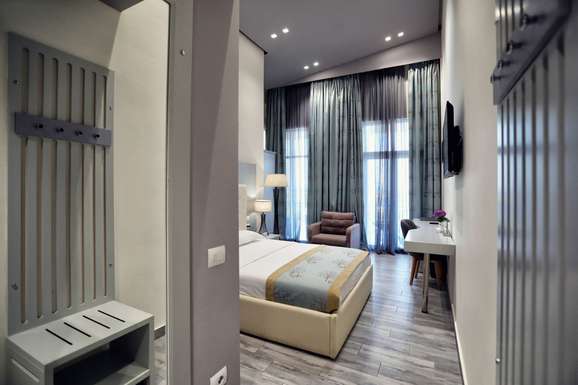 a bedroom with a bed and a desk