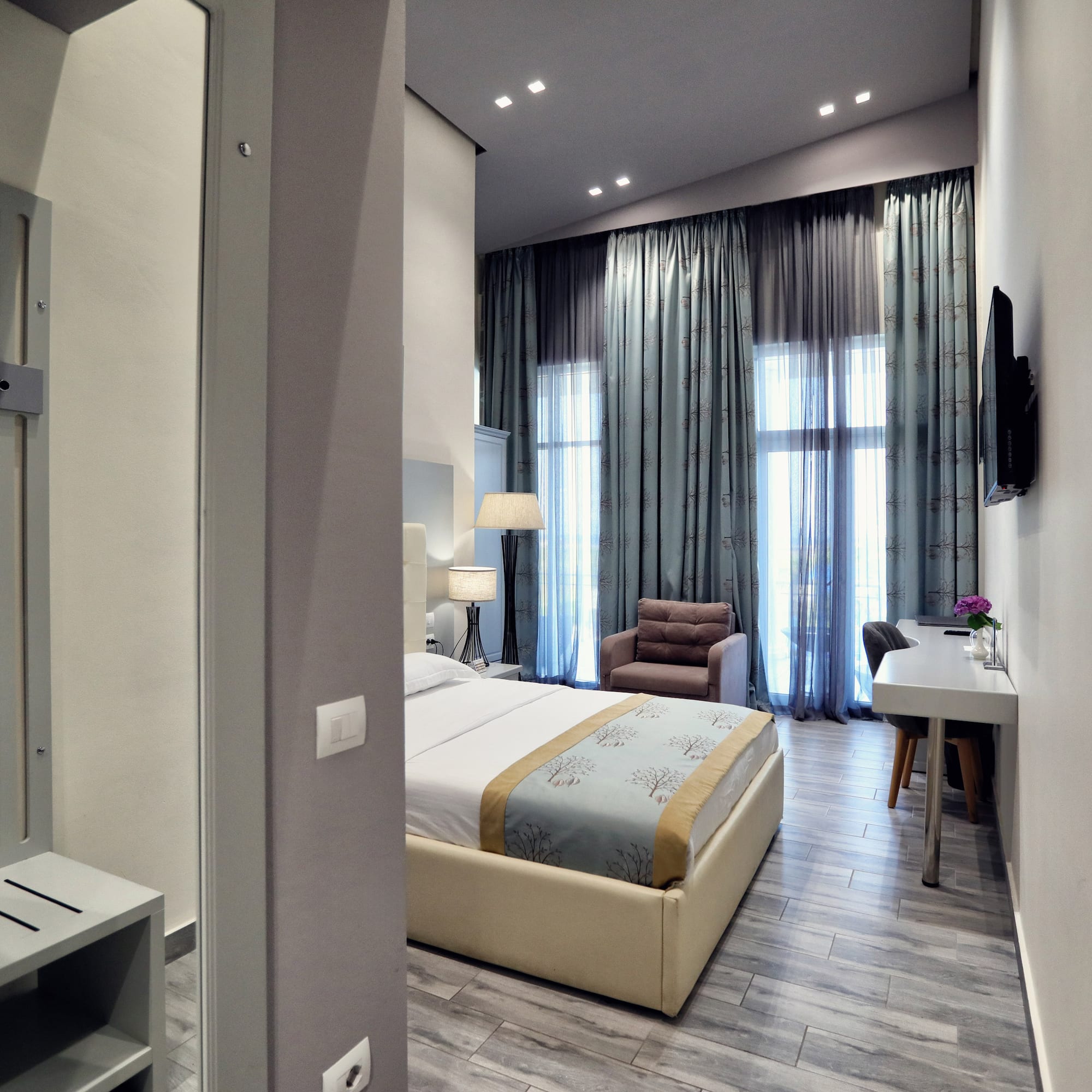 a bedroom with a bed and a desk