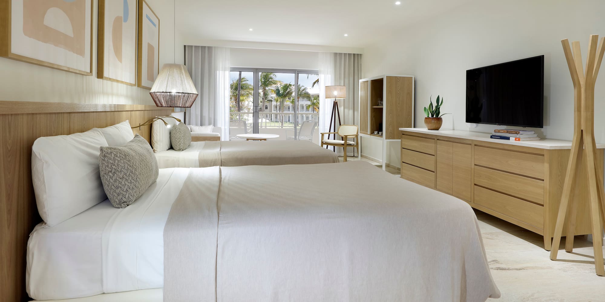 a bedroom with two beds and a television