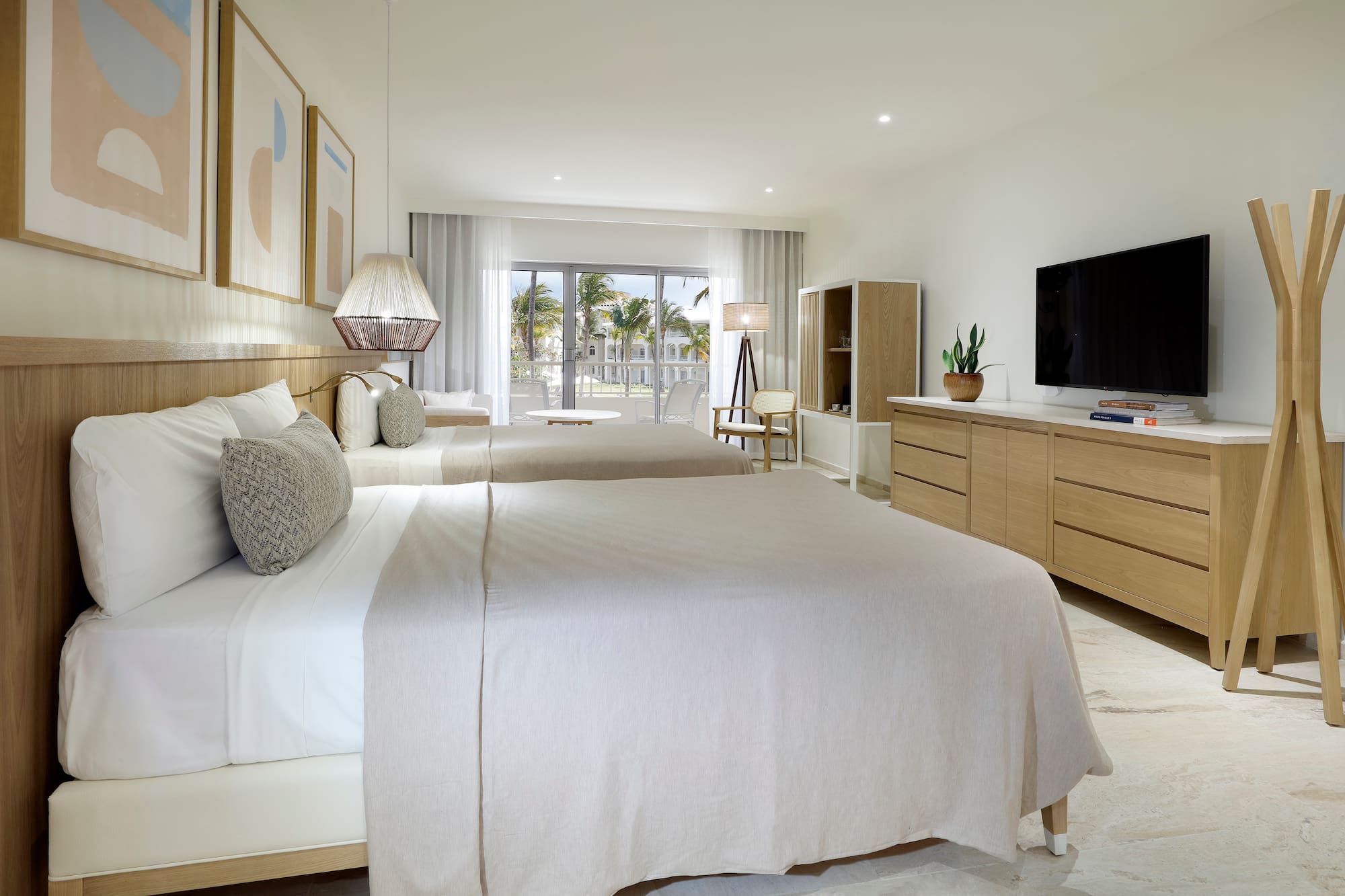 a bedroom with two beds and a television