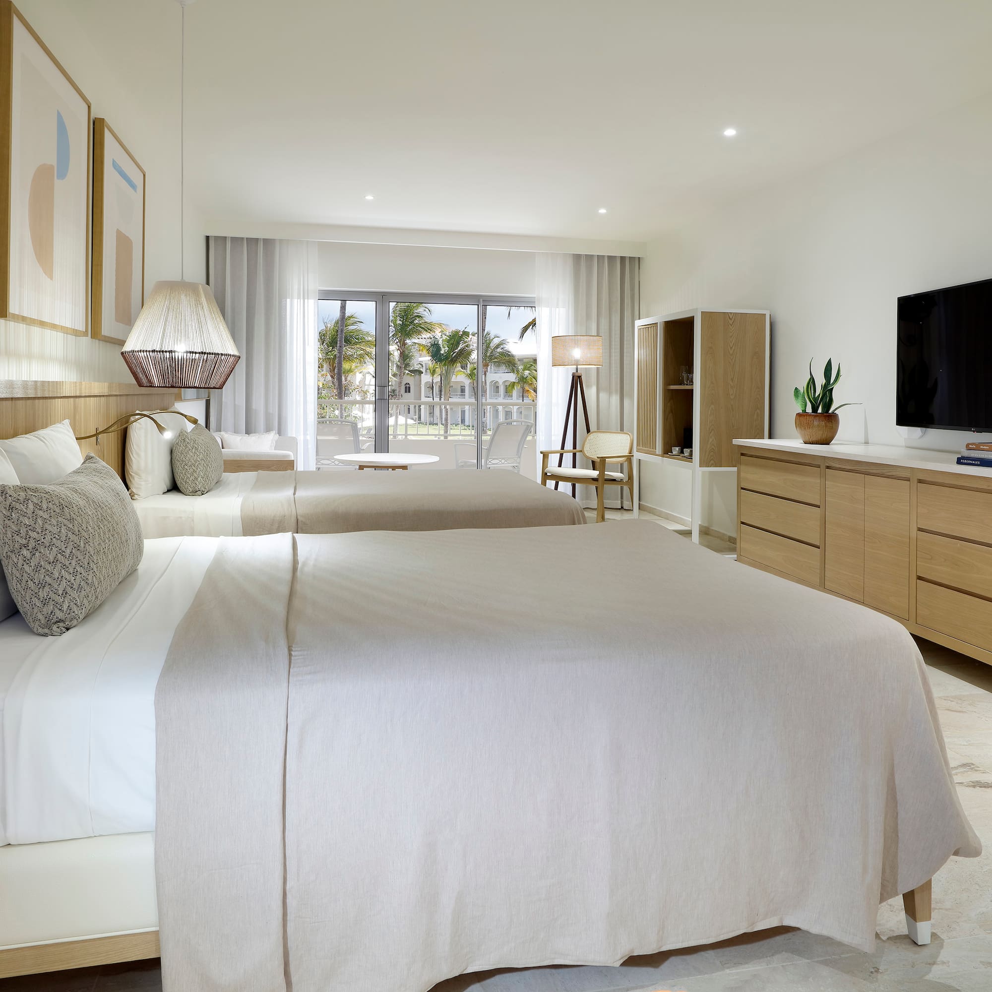 a bedroom with two beds and a television