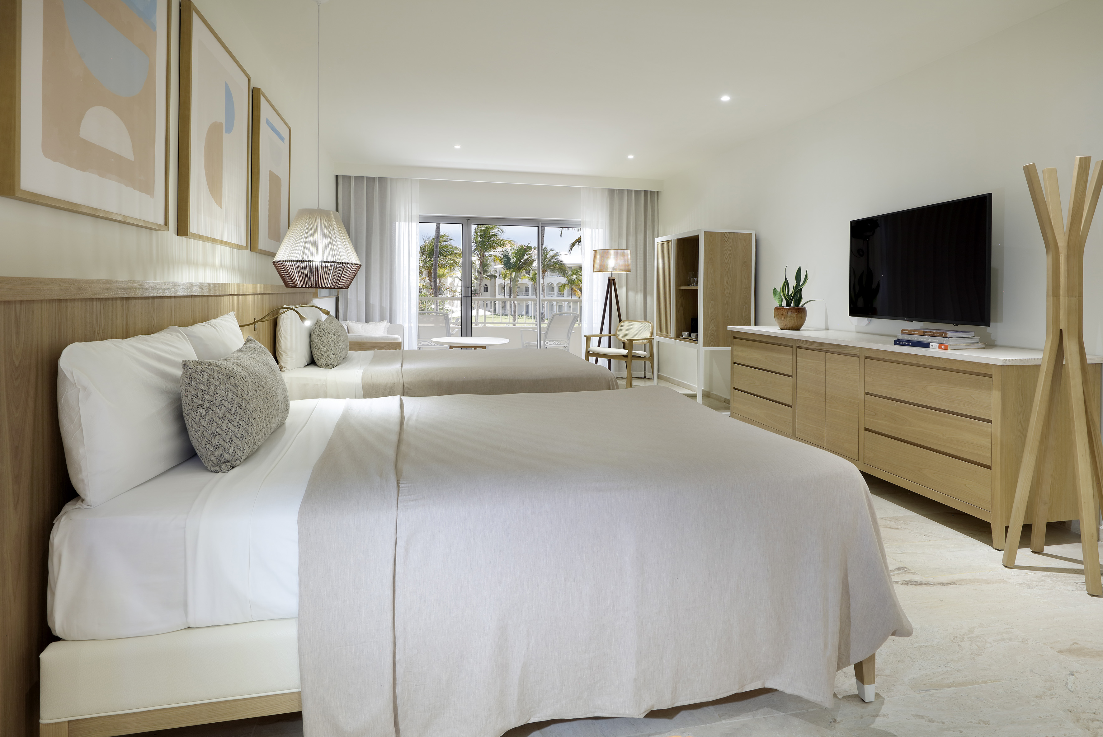 a bedroom with two beds and a television