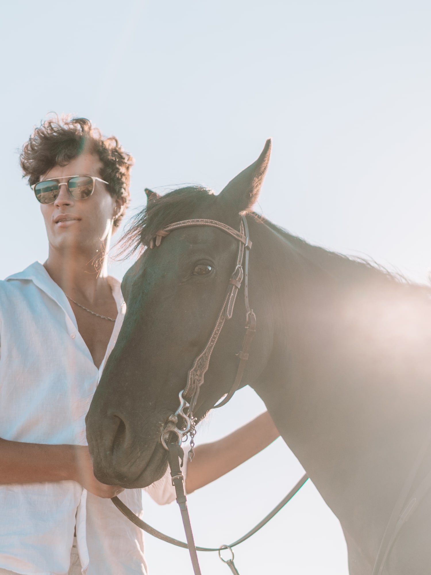 a man standing next to a horse