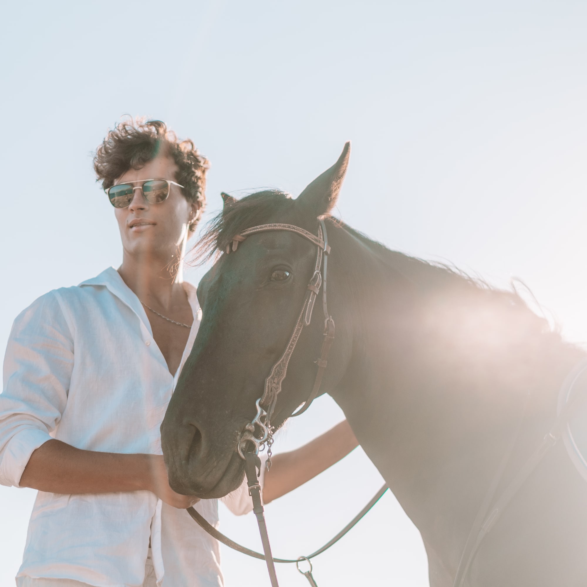 a man standing next to a horse