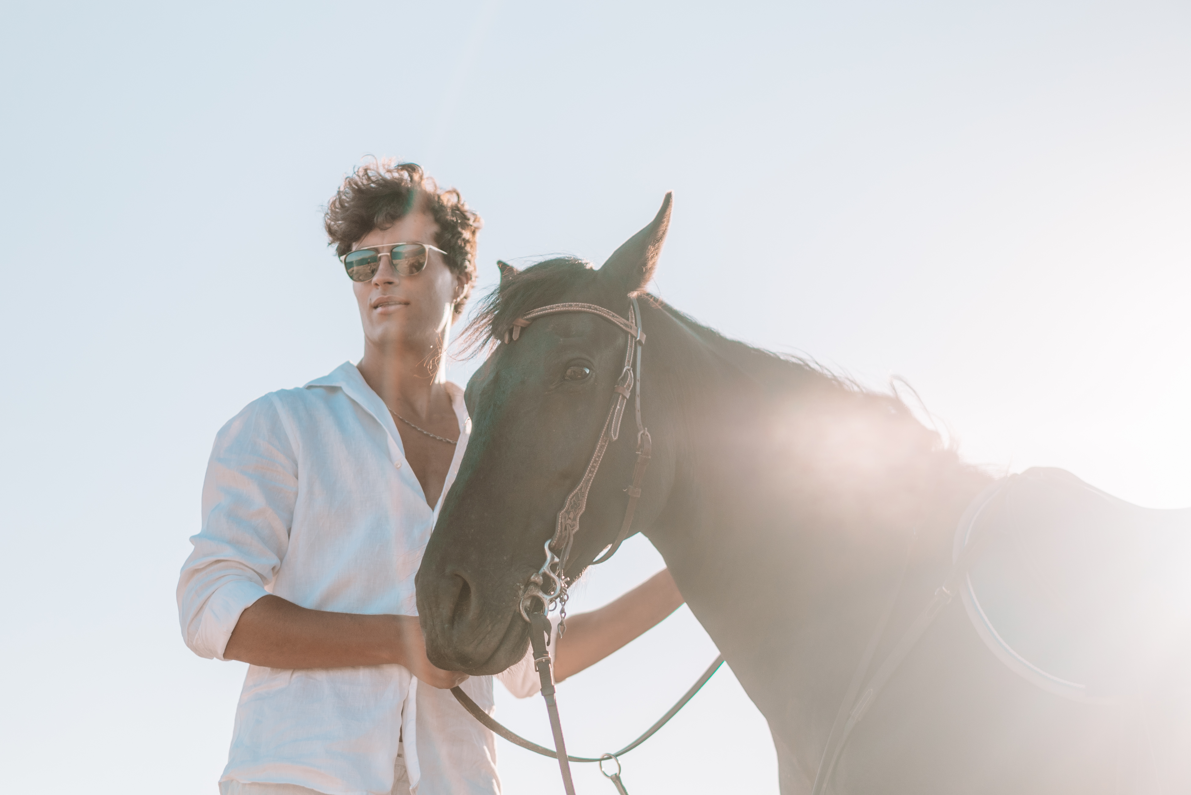 a man standing next to a horse