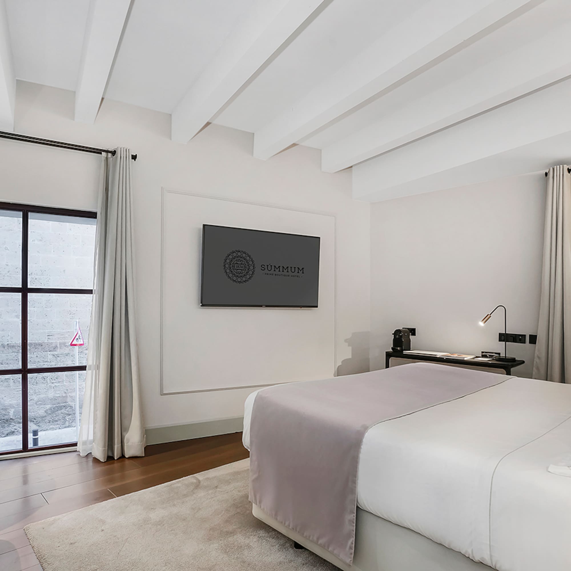 a bedroom with a bed and a tv