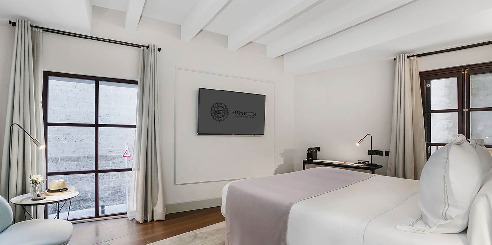 a bedroom with a bed and a tv