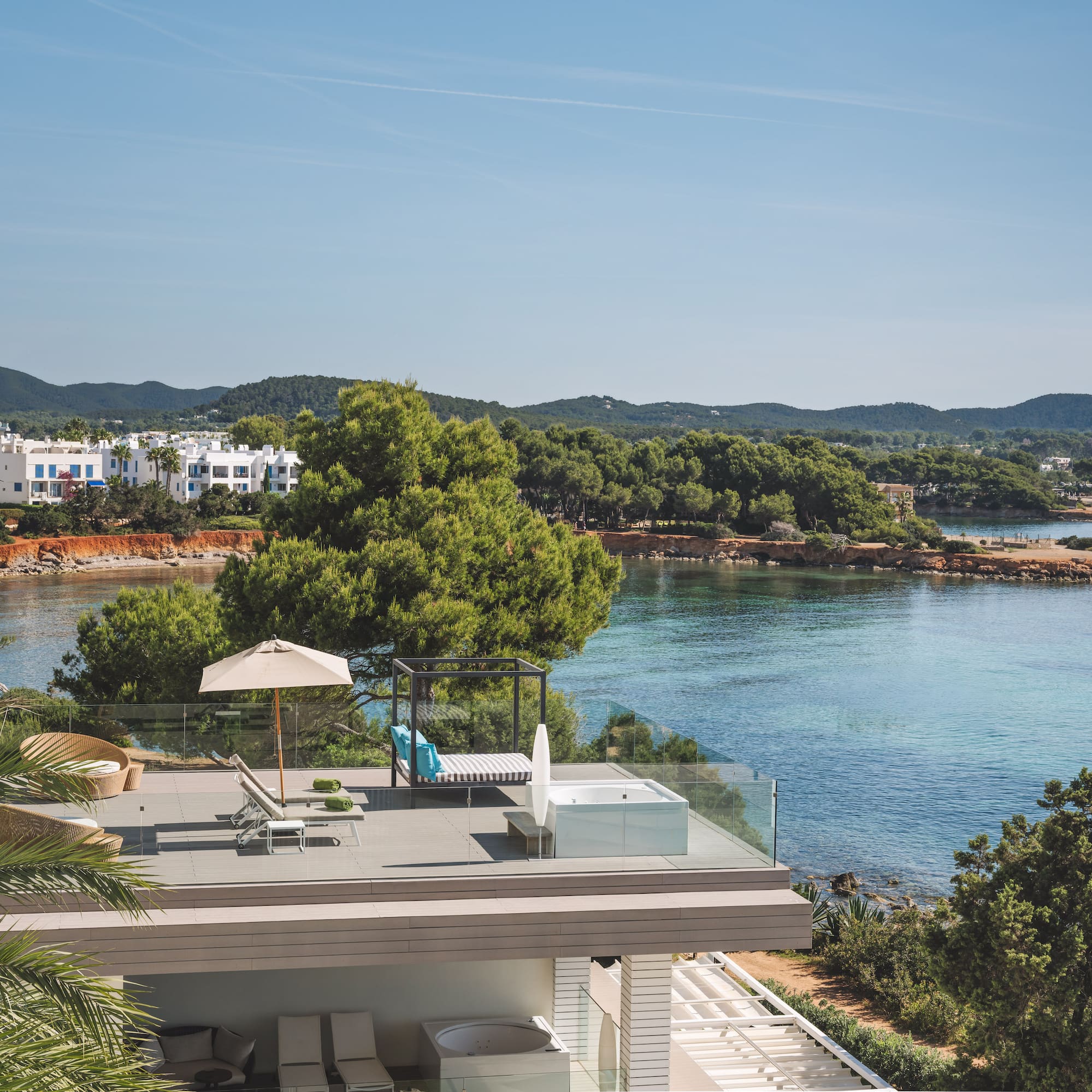 Luxury terrace with hot tub, daybed, and Mediterranean sea views.