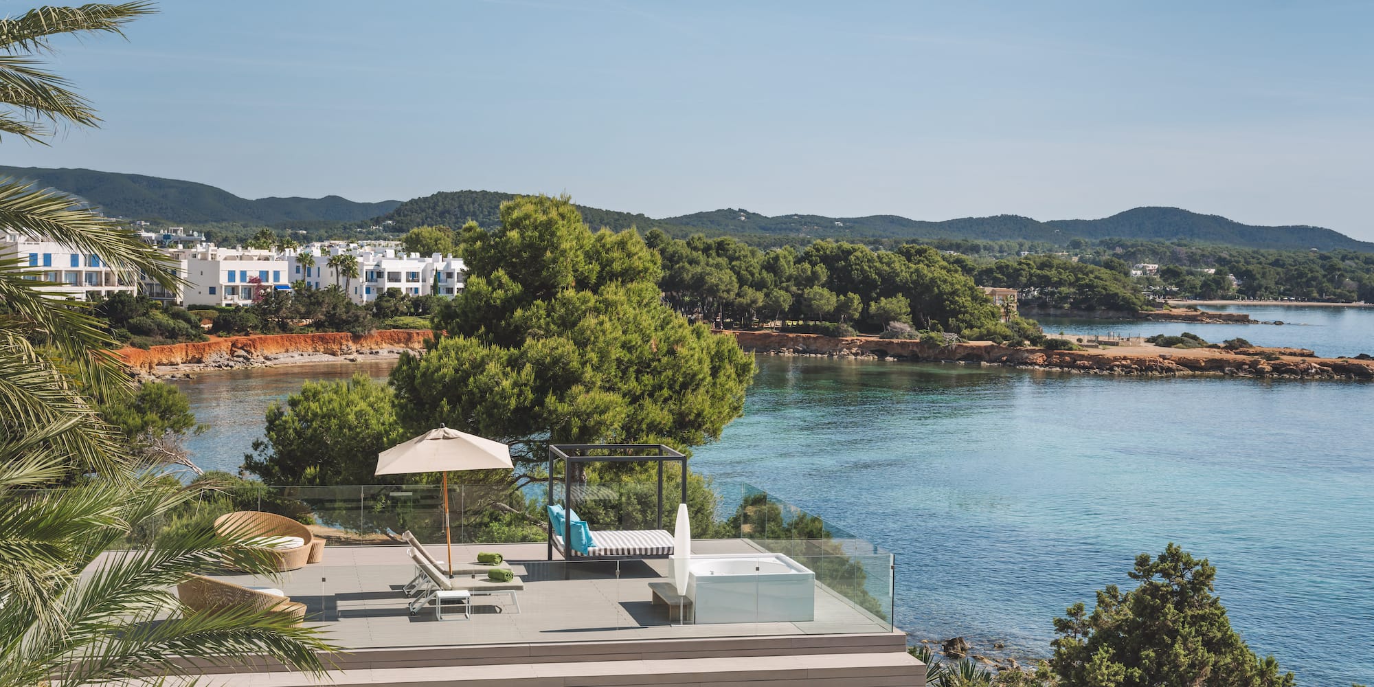 Luxury terrace with hot tub, daybed, and Mediterranean sea views.