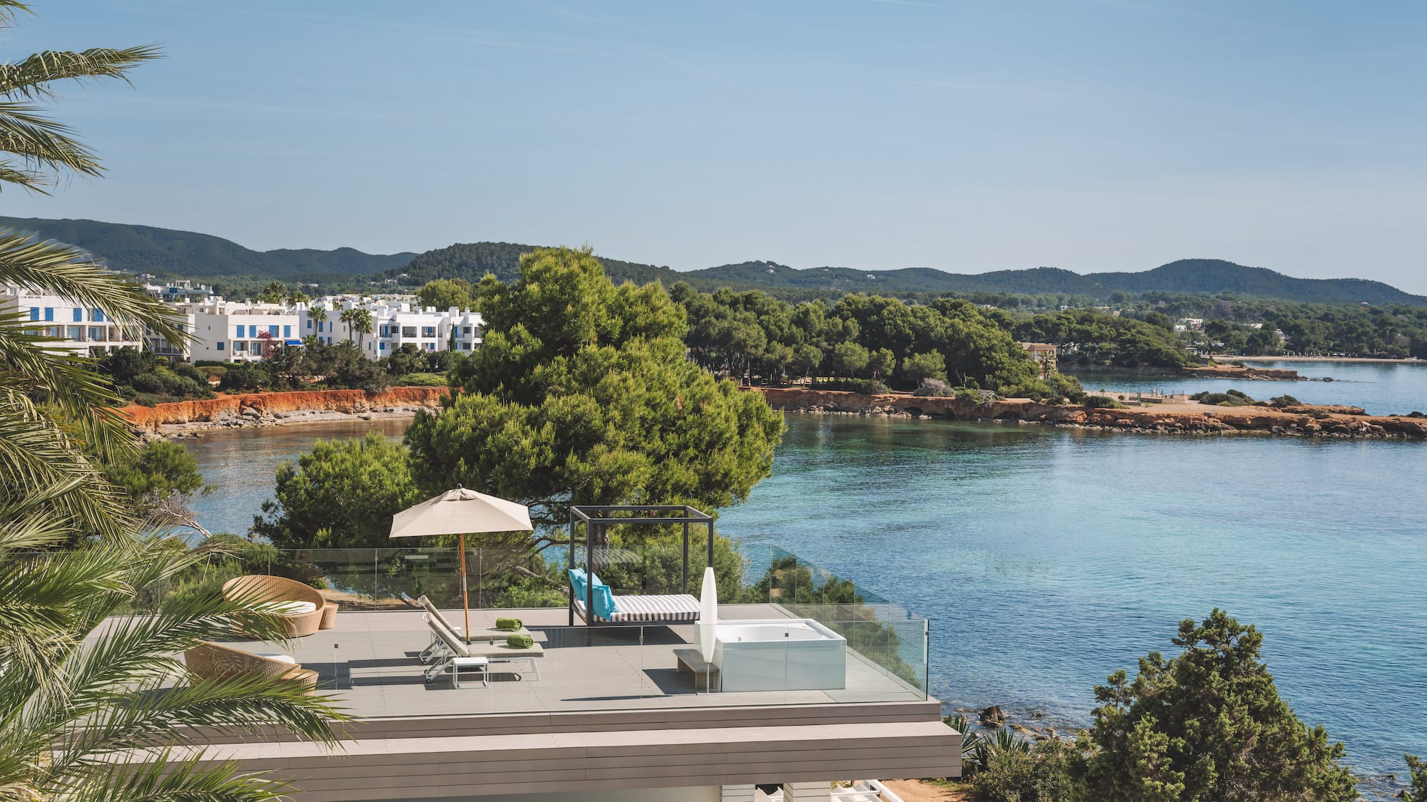 Luxury terrace with hot tub, daybed, and Mediterranean sea views.