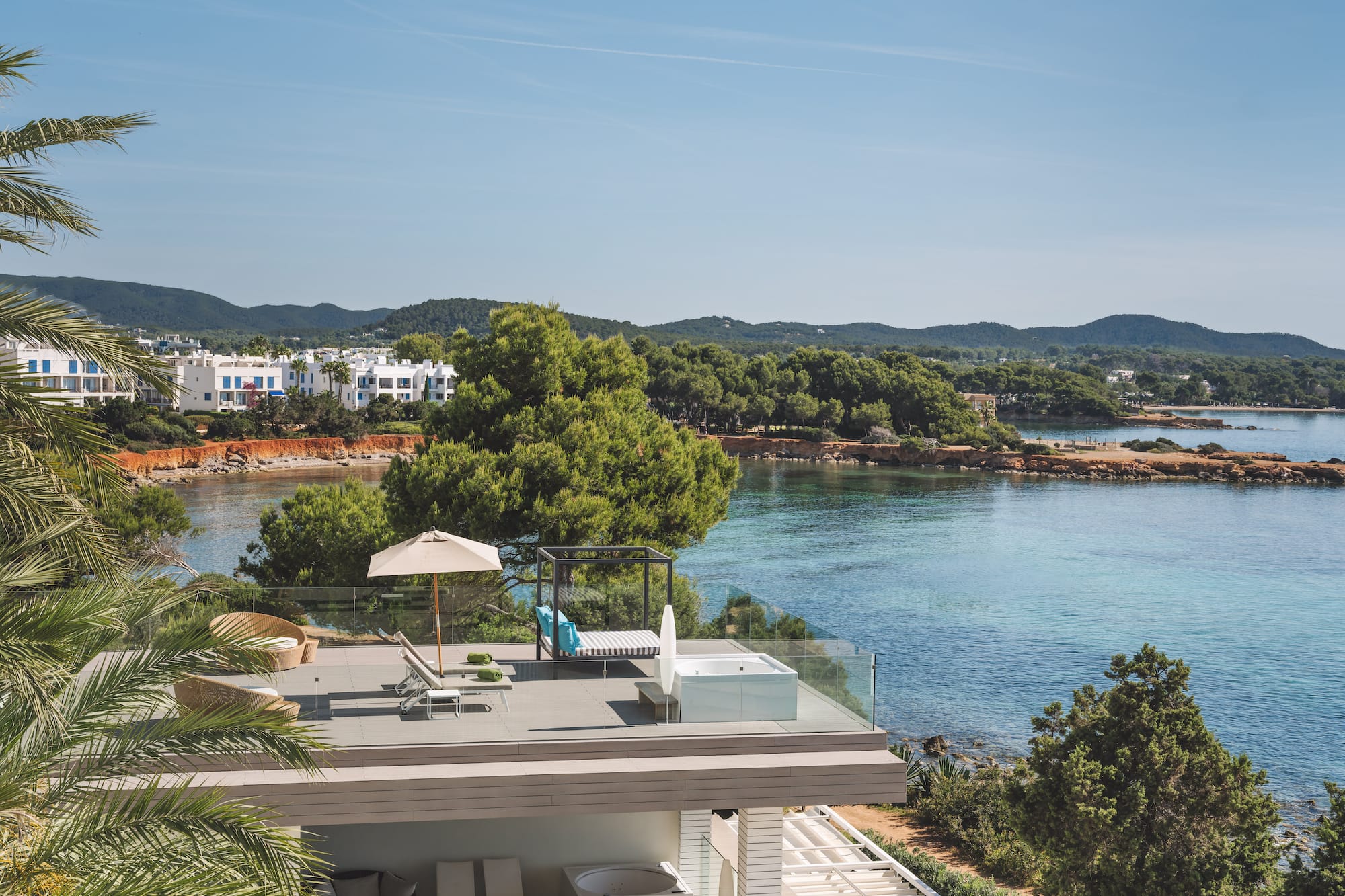 Luxury terrace with hot tub, daybed, and Mediterranean sea views.