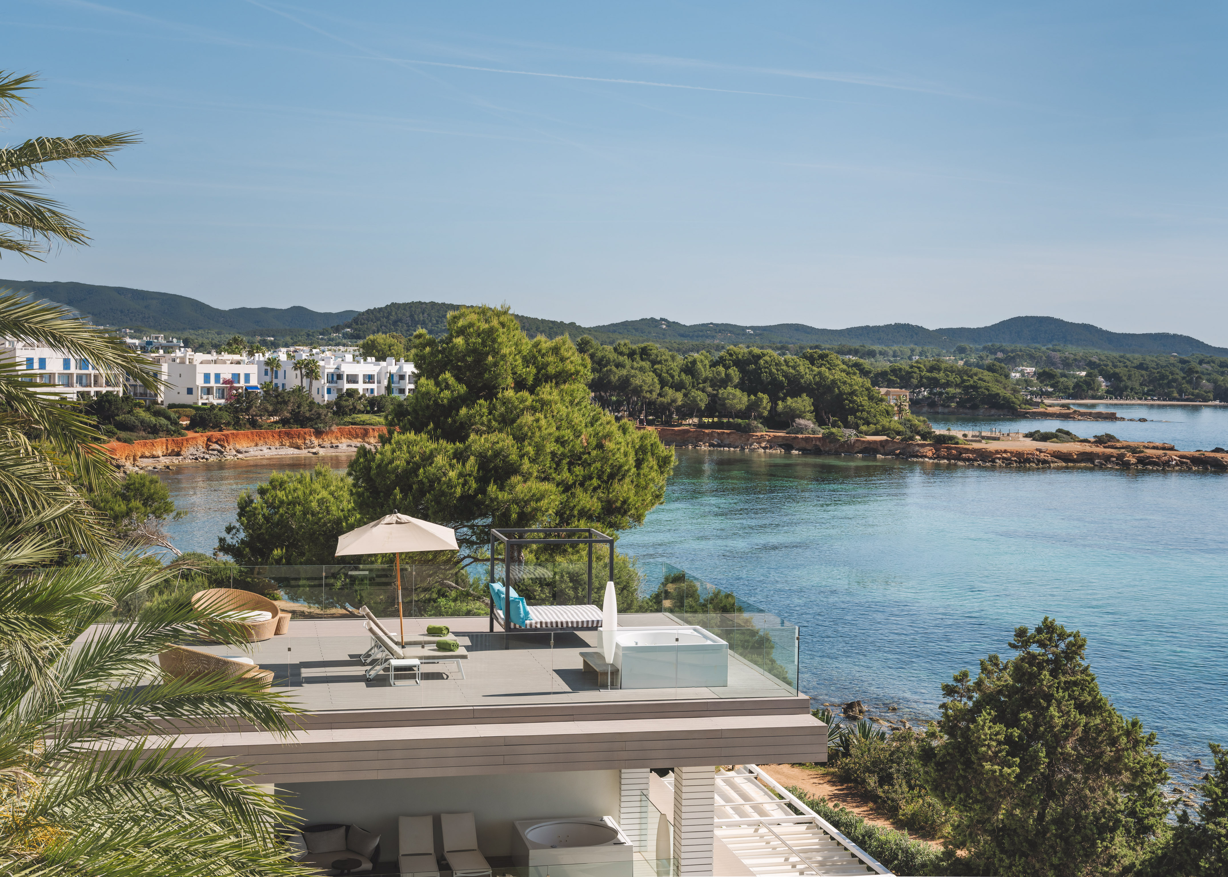 Luxury terrace with hot tub, daybed, and Mediterranean sea views.