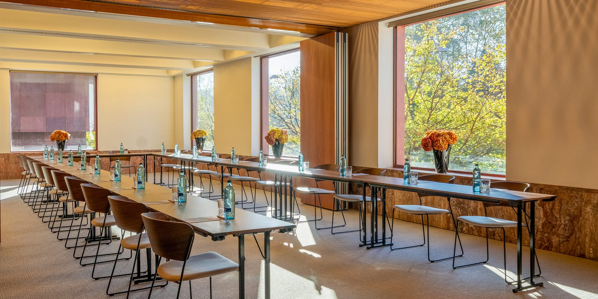 a room with tables and chairs and flowers