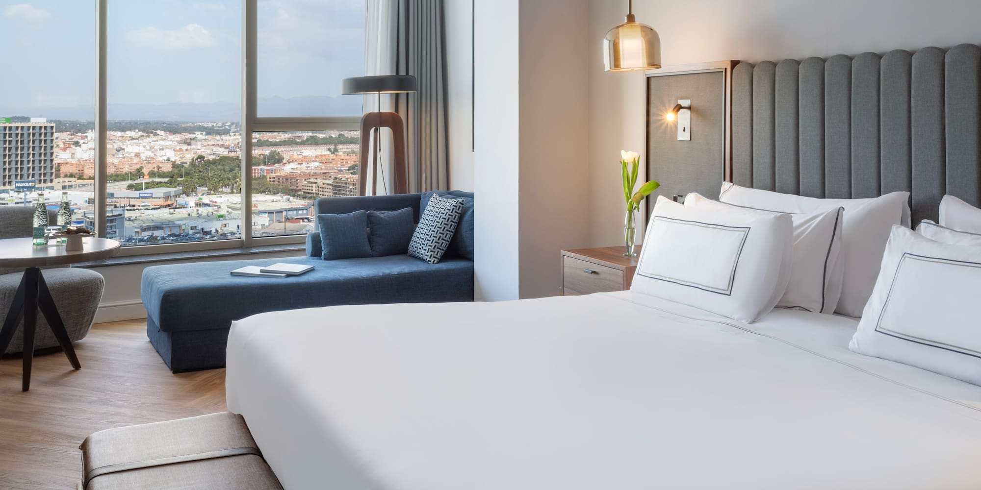 a bedroom with a large bed and a couch