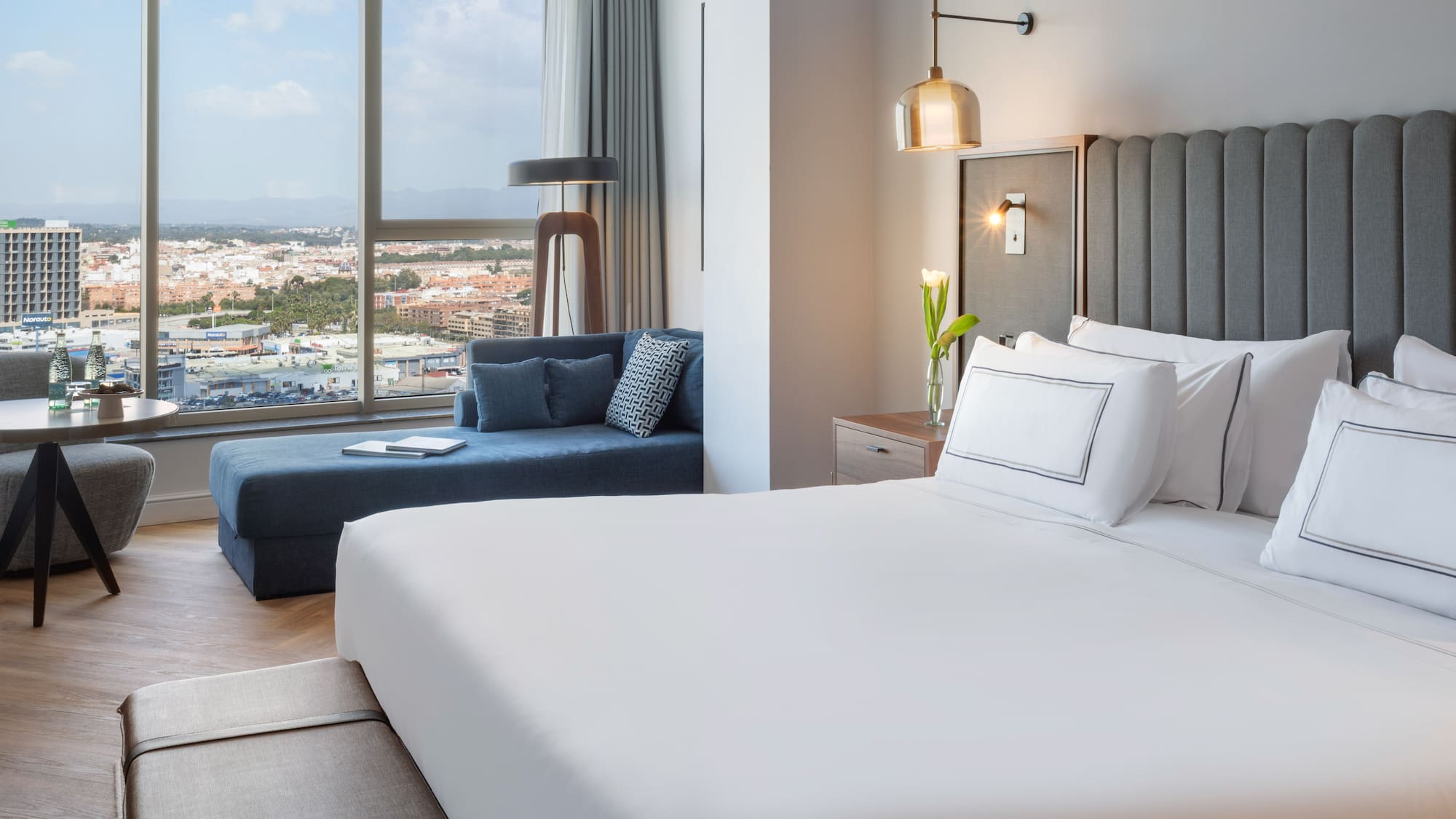 a bedroom with a large bed and a couch