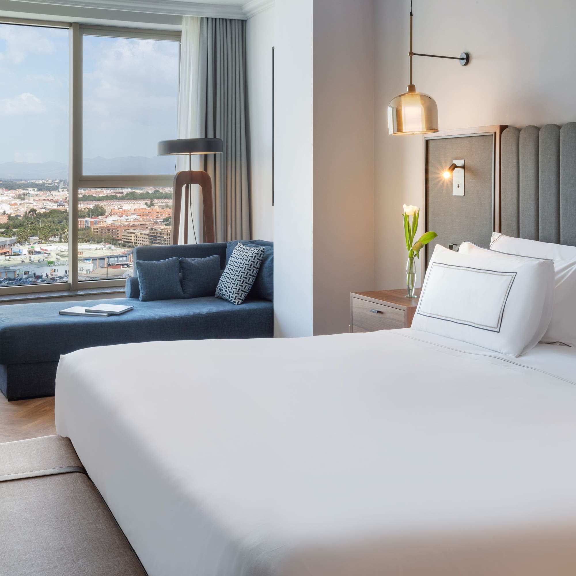 a bedroom with a large bed and a couch