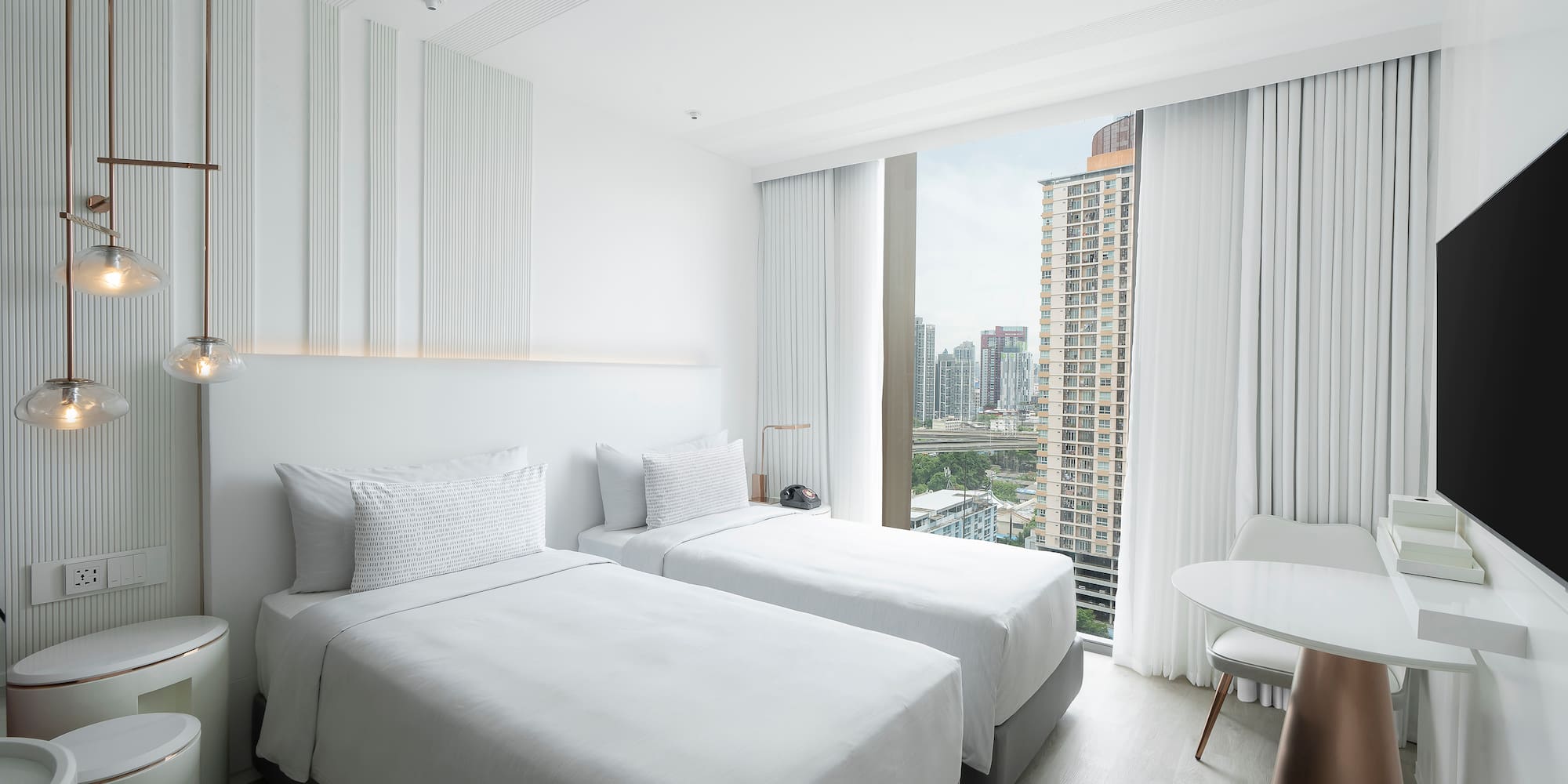 a room with two beds and a table