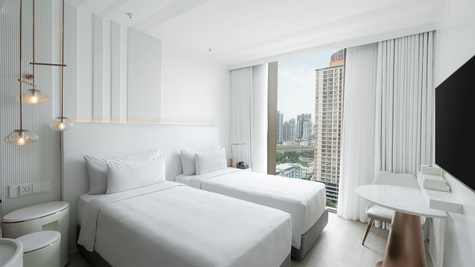 a room with two beds and a table