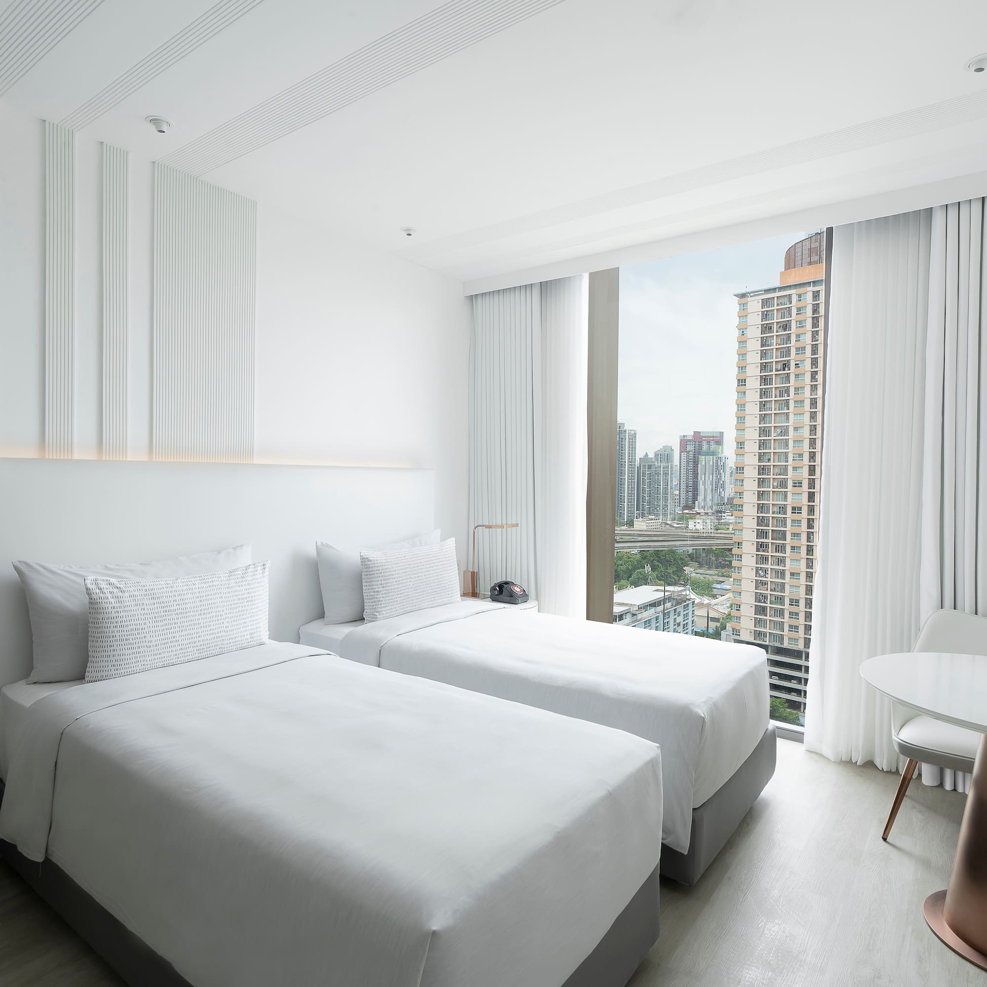 a room with two beds and a table