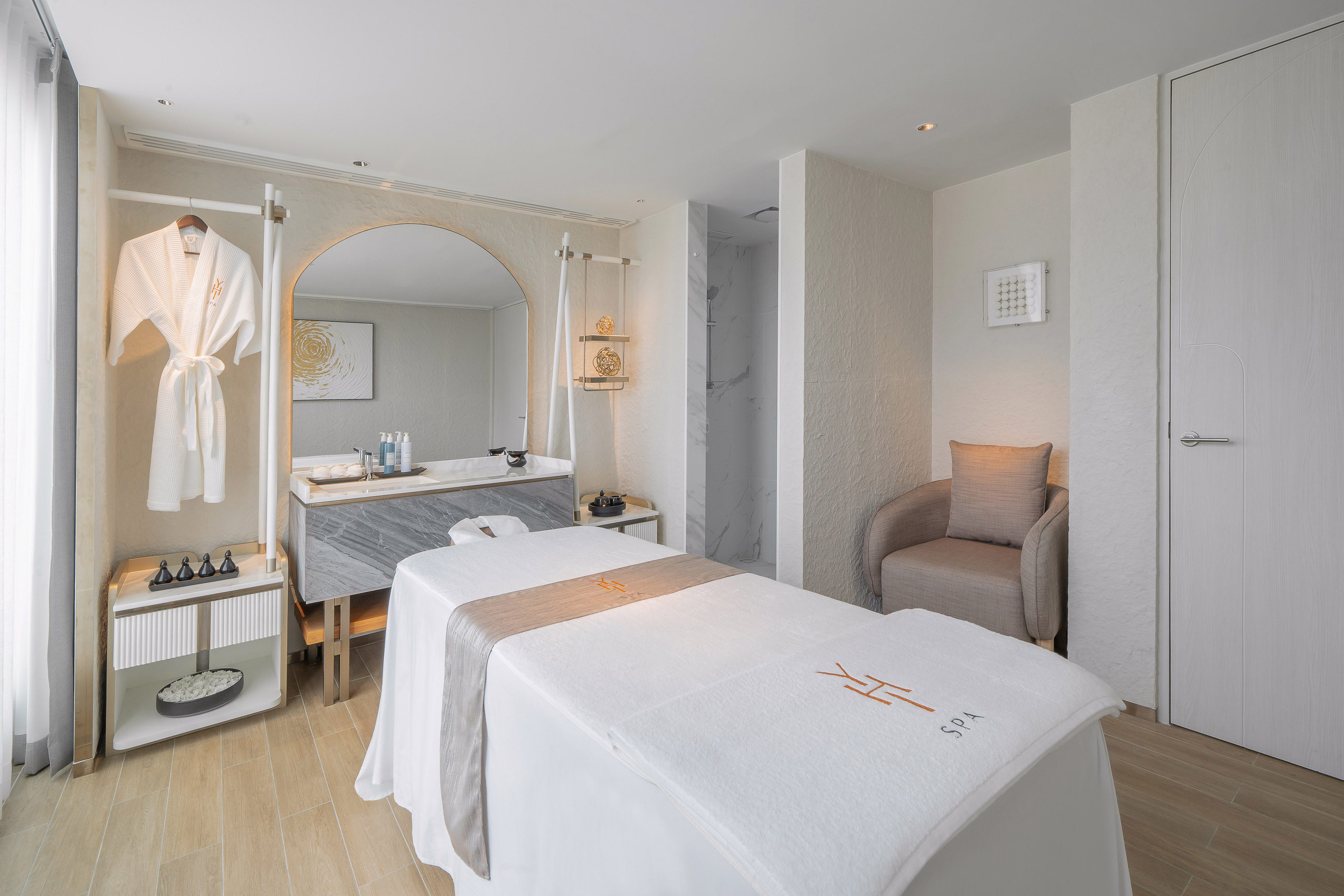 Luxury hotel spa treatment room with massage bed, vanity, and shower. - YHI Spa - Meliá Pattaya Hotel, Pattaya