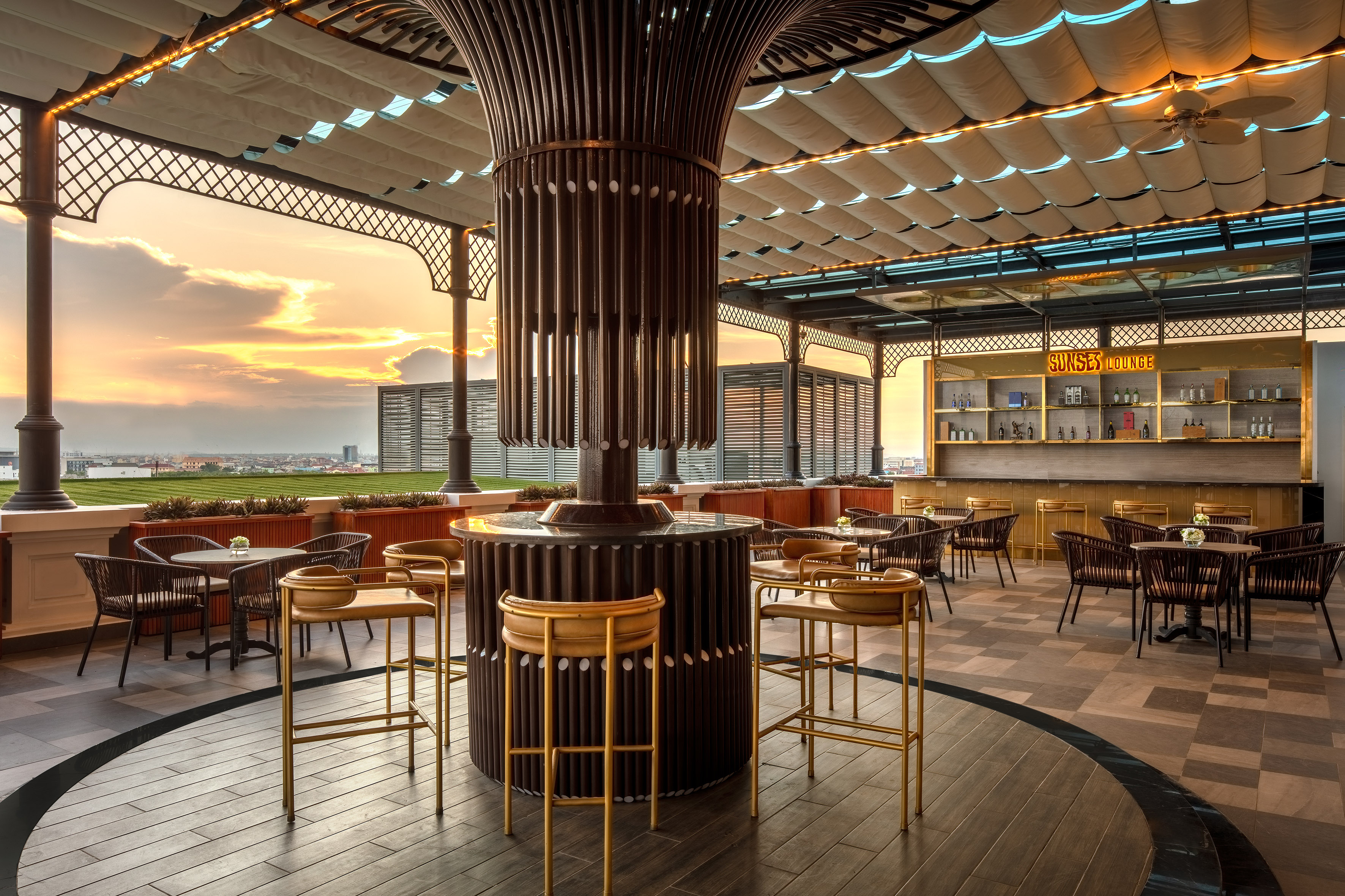 Modern Sunset Lounge rooftop bar with outdoor seating and city sunset.