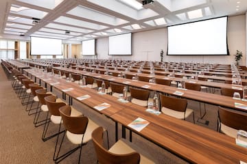 a large conference room with tables and chairs
