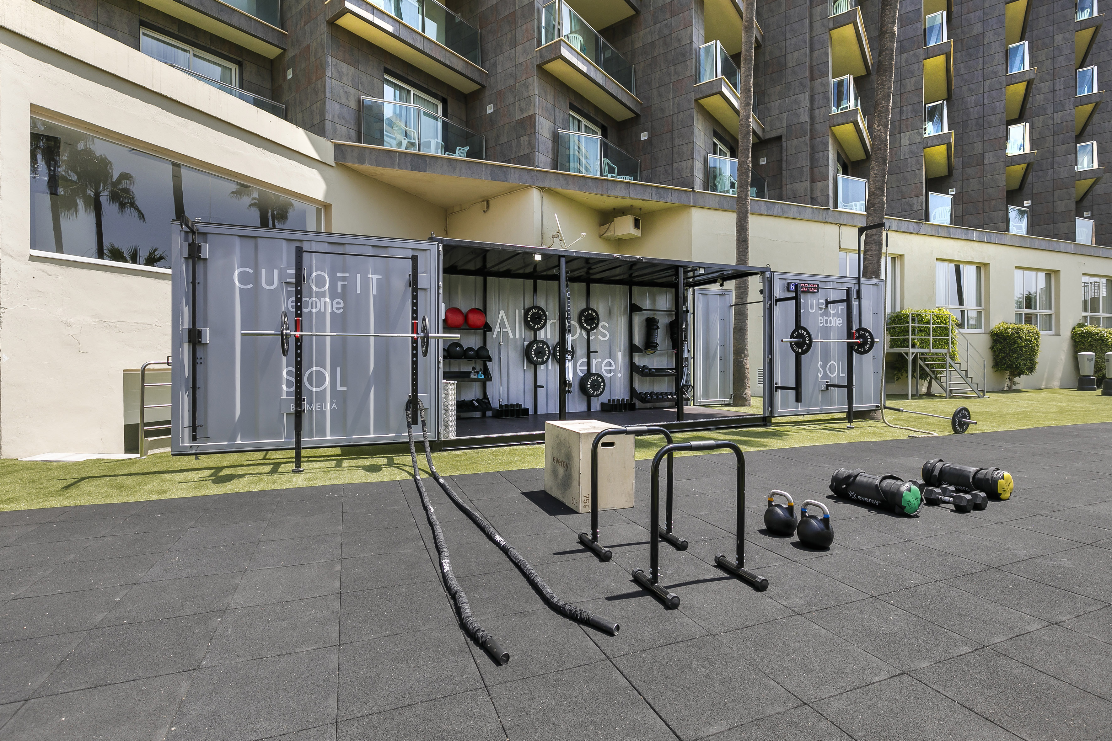 Outdoor gym with fitness containers and workout equipment at Sol Meliá hotel.