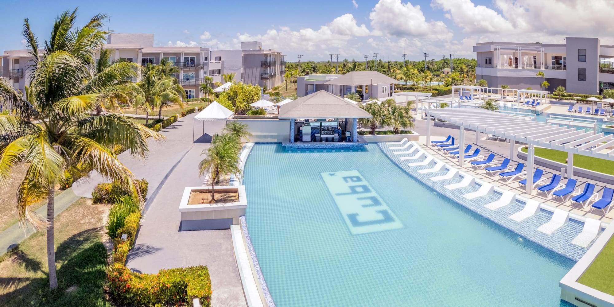 a swimming pool with lounge chairs and a bar