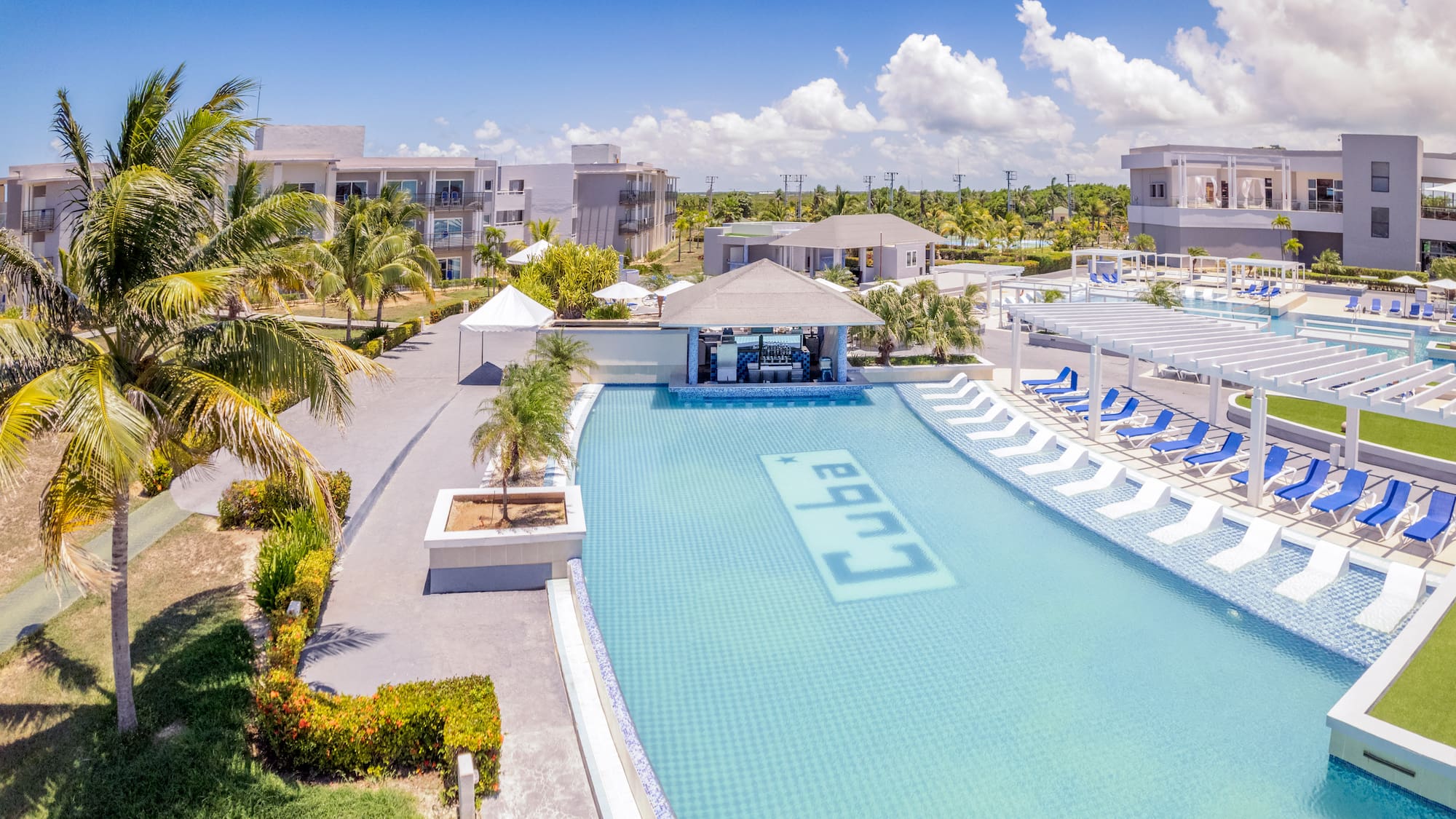 a swimming pool with lounge chairs and a bar