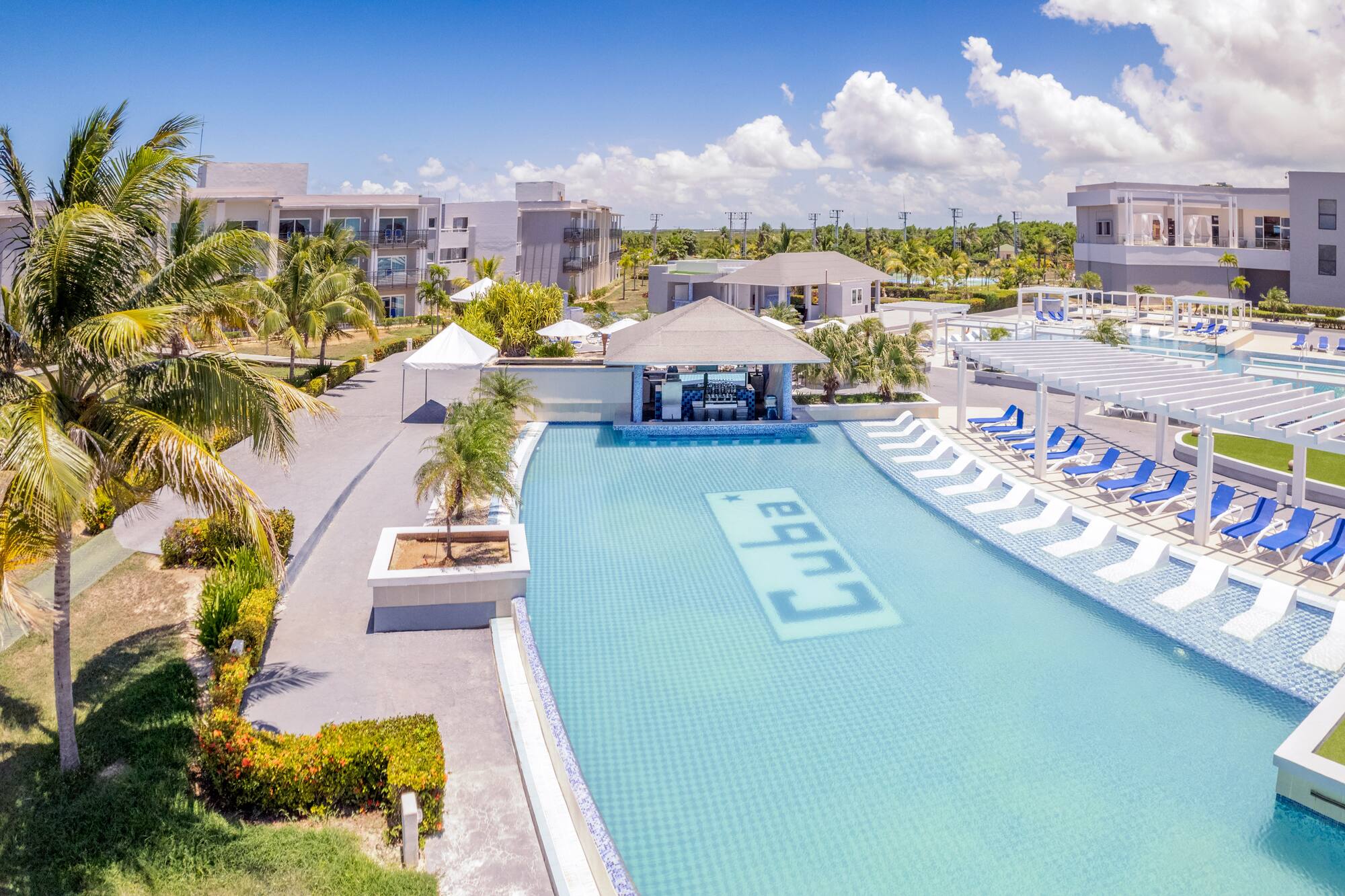 a swimming pool with lounge chairs and a bar