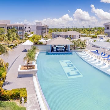 a swimming pool with lounge chairs and a bar