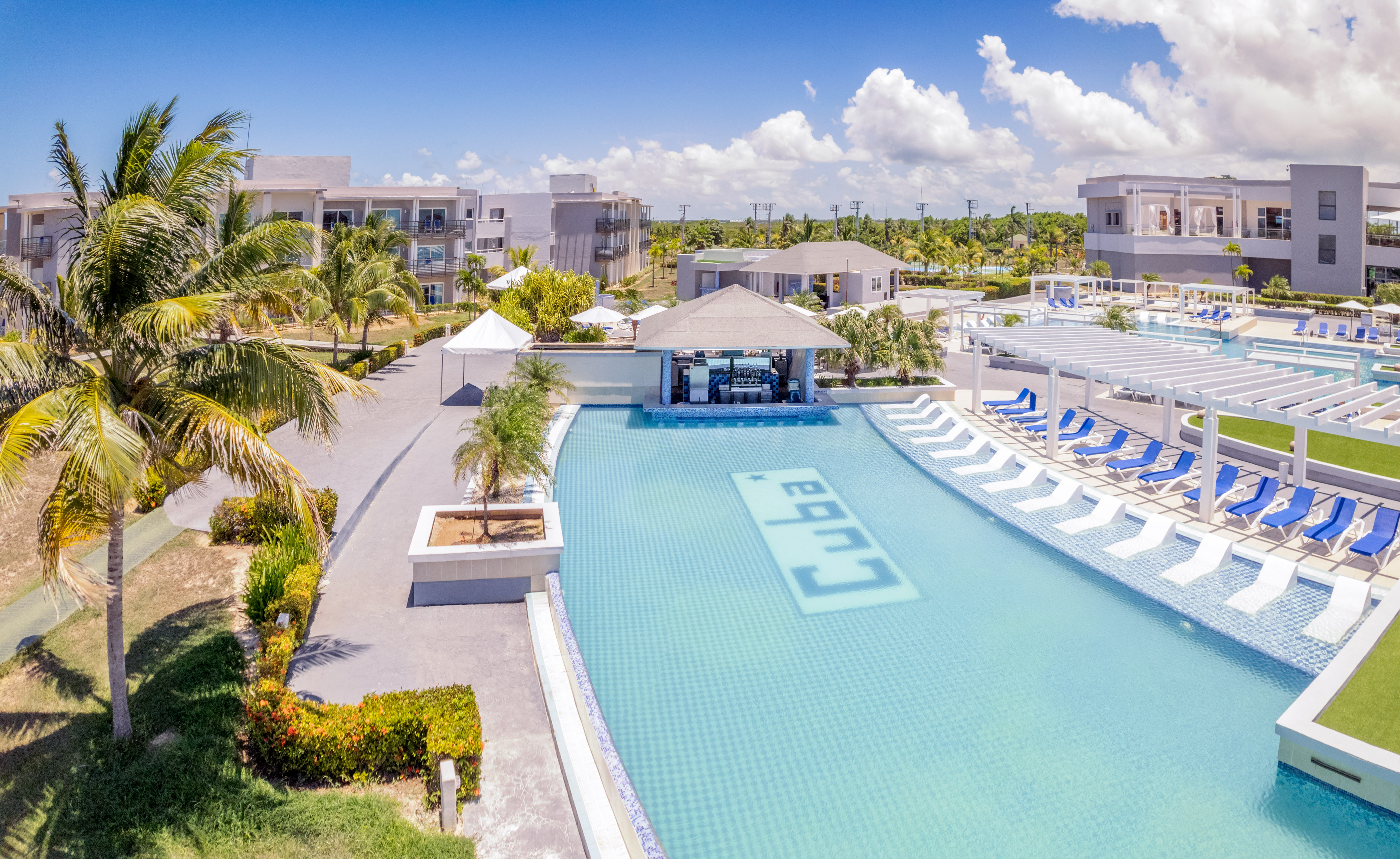 a swimming pool with lounge chairs and a bar